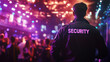 © Michael - Security guard monitors a nightclub party with purple lights, ensuring safety. Standing at the back, they watch over dancing people in a vibrant bokeh background