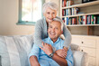© Malambo/peopleimages.com - Hug, love and portrait of senior couple on sofa for connection, bonding and relaxing together at home. Smile, happy and elderly man and woman embracing, marriage and resting at house in Canada.