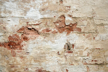 Old wall made of brick and plaster