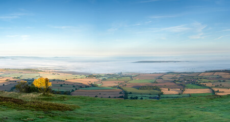 A panoramic view from the Wrekin Hill in Telford, Shropshire, UK looking over the countryside west towards the Welsh Hills on a misty morning