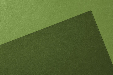 Green colored paper texture background. Abstract paper background in olive green tones