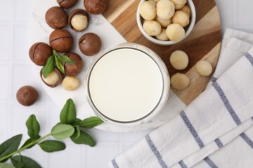 Sticker - Glass of macadamia milk and nuts on white tiled table, flat lay