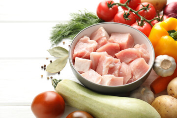 Sticker - Uncooked ingredients for stew on white wooden table, closeup