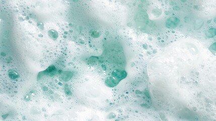  A tight shot of a foamy surface teeming with bubbles and droplets of water atop the foam