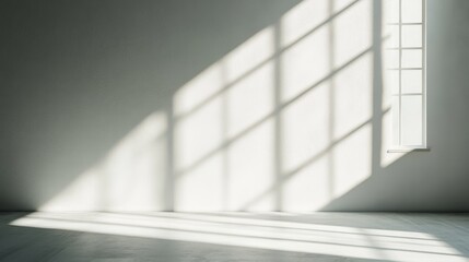 Poster - Natural light streams into a simple room through a minimalist window, creating striking shadows across the smooth wall, enhancing the tranquil atmosphere