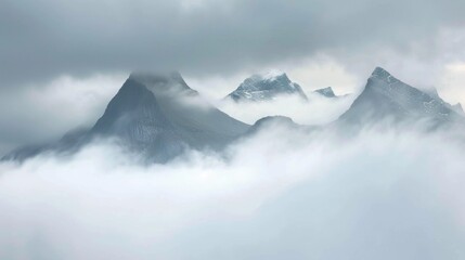 Poster - Aerial view of a plane flying above a mountainous region covered in clouds