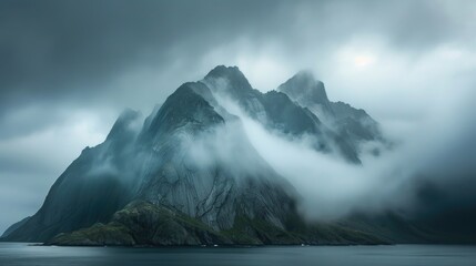 Wall Mural - A misty mountain landscape with a body of water nearby, great for use as a calm background or atmospheric scene