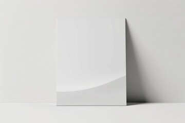 Poster - A blank white poster leaning against a wall