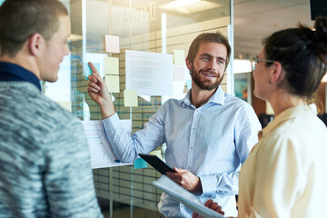 Poster - Tablet, people and glass wall for brainstorming ideas in startup for collaboration and teamwork. Group, talking or people in meeting discussion for solution, planning or project in creative agency