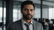 © Alteisen Riese - adult black hair european man in gray formal attire model portrait looking confident on an office background for ad concept space for text
