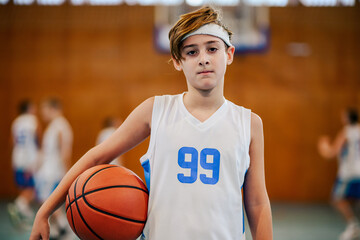 Wall Mural - Teenage basketball player holding the ball