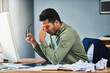 © SensSai/peopleimages.com - Man, stress and headache in office by computer with glass, pain or red glow with chaos at company. Business person, tired and fatigue with migraine, exhausted and burnout with mess by pc at workplace