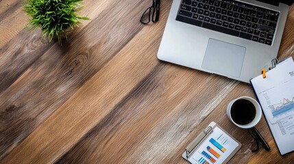 Poster - Laptop on a wooden desk with financial graphs and charts, office supplies arranged neatly.
