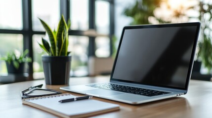 Poster - Open laptop on a desk with a blank notepad and pen, ready for work in a contemporary office setting.