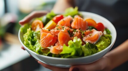 Wall Mural - Healthy Young woman holding Salted salmon salad bowl with fresh green lettuce,smoked salmon,tomato,Ketogenic,diet lunch bowl,enjoy eat clean vegetables after exercise,Healthy food concept.