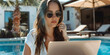 © Marc Kunze - beautiful blonde freelancer using laptop while sitting near swimming pool