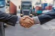 © MahmudulHassan - Businessman shake hands with logistic import export and transport industry background