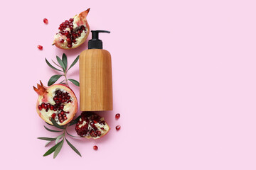 Wall Mural - Composition with bottle of cosmetic product and ripe pomegranate on pink background