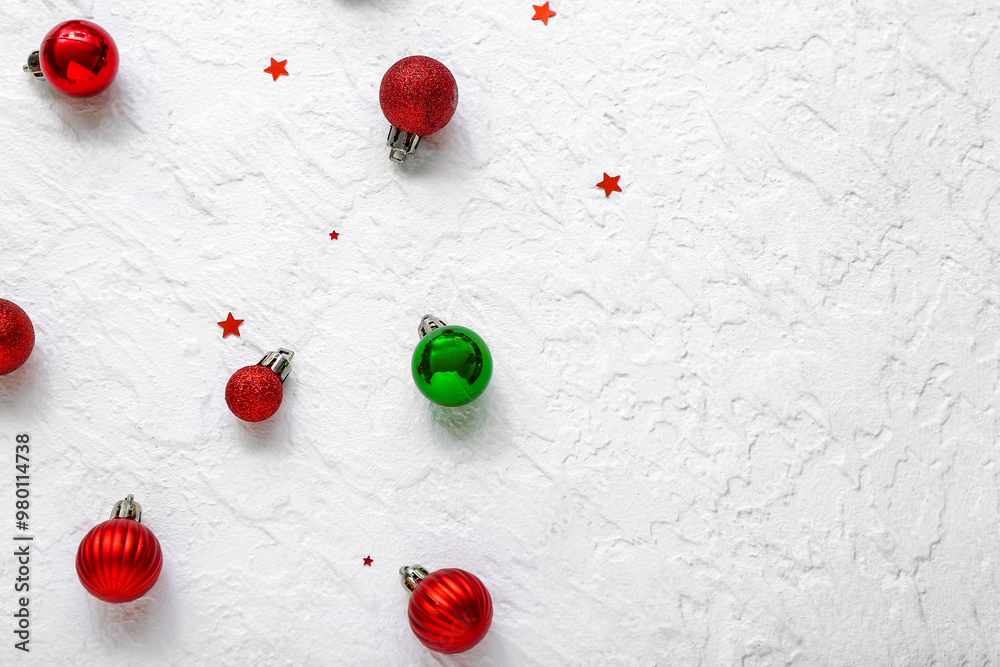 Christmas balls and confetti on white background