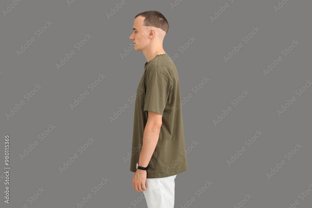 Handsome young man in stylish t-shirt on grey background
