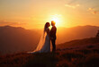© SophieK - Bride and Groom Silhouette at Mountain Sunset: A newly married couple stands together on a hilltop, silhouetted against a vibrant orange and gold sunset sky.