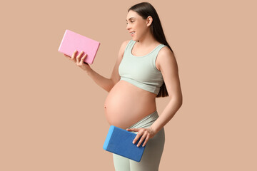 Sticker - Young pregnant woman with yoga blocks on color background