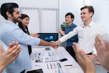 Wall Mural - Analyst team leader shake hand with his colleague after successful data analysis meeting using FIntech software power with business intelligence or BI dashboard. Prudent