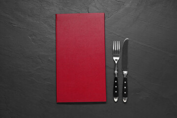 Wall Mural - Hardcover menu and cutlery on grey textured table, flat lay