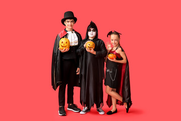 Canvas Print - Kids dressed for Halloween with pumpkins on red background