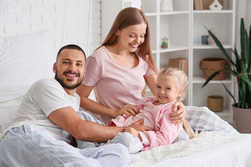 Sticker - Happy parents tickling their little daughter in bedroom