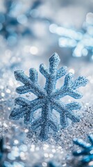 Poster - Close-up of a blue snowflake decoration surrounded by snow, with a glowing background. Festive Christmas and New Year decoration.
