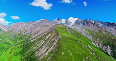 Poster - Aerial view of green meadows and spectacular mountain natural landscape in Xinjiang, China. Beautiful mountain range scenery in summer.