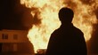 © Business Image - Dramatic silhouette against intense fire at night – concept of resilience and danger for print or poster