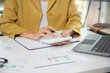 © weerachai - Business finance woman calculating budget numbers, Invoices and financial adviser working.