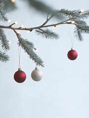 Poster - Minimalistic Christmas Tree Branch with Red and Gold Ornaments and Fairy Lights on White Background