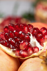 Wall Mural - open pomegranates, and pomegranate seeds on wooden table.