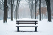© Thanapong - A snow-covered bench in an empty park, with bare trees and a quiet atmosphere, reflecting solitude and the stillness of winter