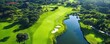 © AIsofeel - A scenic aerial view of a lush green golf course with a serene water feature, perfect for outdoor sports and relaxation.