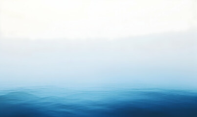 Minimalist seascape with a foggy horizon and calm blue water.