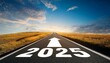 © Hamad Baloch - Road to 2025 with an empty road with written 2025 and arrow pointing towards the horizon to represent the future and positivity and success of the new year 2025