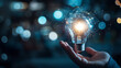© Hikmet - Businessman’s hand holding a creative light bulb with industry network, analysis solutions, development marketing network icons, and strategic planning. Modern business and innovation of new ideas.