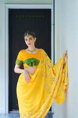 Beautiful fashionable Indian woman wearing Hindu Bride in a saree dress a traditional costume.  Portrait of a young Indian woman model in Traditional Indian costume the lehenga choli sari outfits.