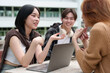 © crizzystudio - Attractive Asian college students using laptop, tablet, mobile phone to study online social media Finding knowledge together, talking, working as a team. Educational concept success in life.