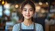 © PicTCoral - Portrait of a Smiling Young Woman in a Cafe