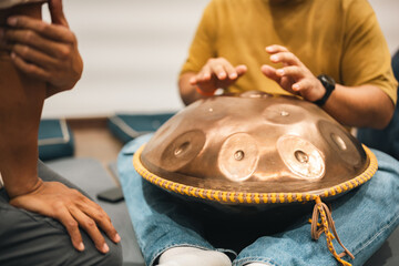 Ethereal Sound of Pan Percussion Instruments, Musician Performs a Peaceful Relaxing Rhythm, Perfect for Meditation and Spiritual Connection, Capturing the Art of Calm with a Hands Playing Metal Drum