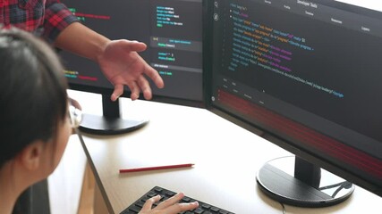 Slow motion back end or software developer manager supervising his team on new application program development on debugging and solving complex code algorithms on monitor. Burgeoning