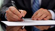 © Xingguo - Confident businessman signing a contract, surrounded by financial documents, symbolizing price guarantees and business security.