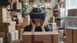 © Ytnart - A woman engages with virtual reality technology amidst a backdrop of cardboard boxes, blending the real and digital worlds.