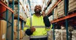 © Nina2024/peopleimages.com - Logistics, black man and phone call at warehouse for distribution, inspection and package inventory. Male person, mobile and discussion for order storage, quality control and supply of stock at depot