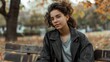 © Aazish Imago - Young woman in glasses sits on a bench